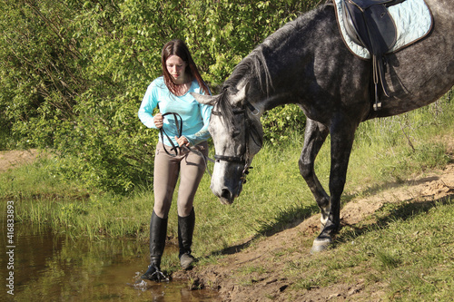 Young girl wants to water a horse