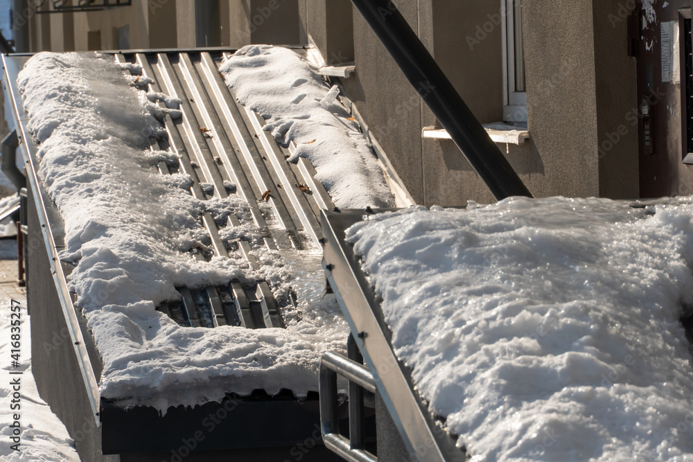The houses are covered with snow and covered with ice after the