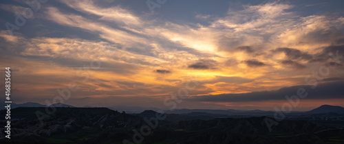 Panoramic mountain landscape with cloudy sky at sunset © Michalis Palis