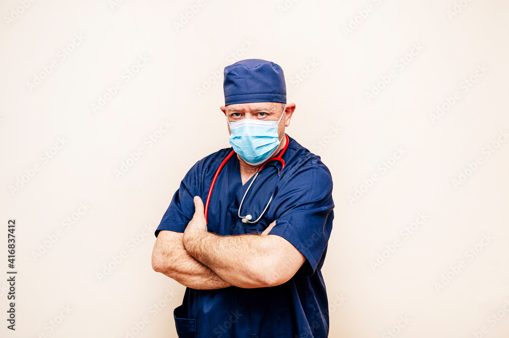Studio portrait of a veteran doctor in an operating room suit Studio portrait of a veteran doctor in an operating room suit