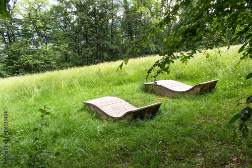 Green spring Parc du Bois Vidal city park with decorative wooden deck chair Aix les bains town Auvergne-Rhône-Alpes region France 