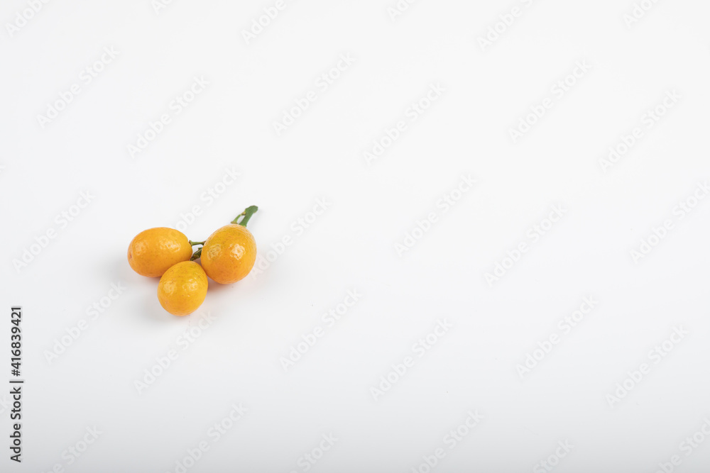 Ripe fresh kumquat fruits isolated on white background Ripe fresh kumquat fruits isolated on white background