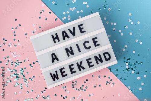 Have a nice weekend - text on display lightbox on blue and pink background. photo