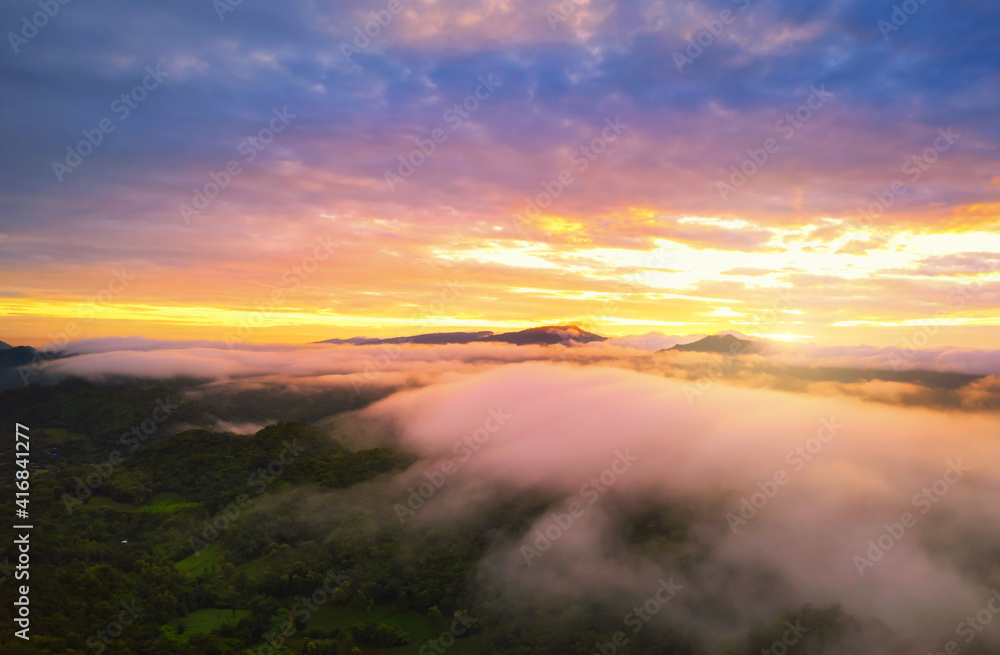 Aerial view Beautiful of morning scenery sea of cloud and the fog flows on high mountains.