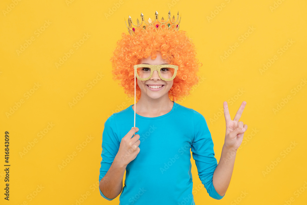 happy teen girl in fancy clown wig wear queen crown and funny party glasses show peace gesture, fun