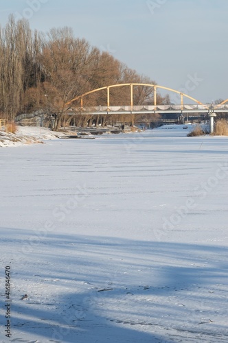  View of the river covered with ice and snow, and the bridge 
