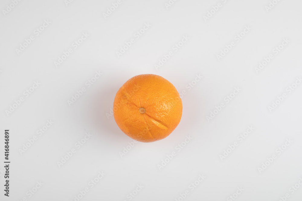Single whole fresh orange isolated on white surface Single whole fresh orange isolated on white surface