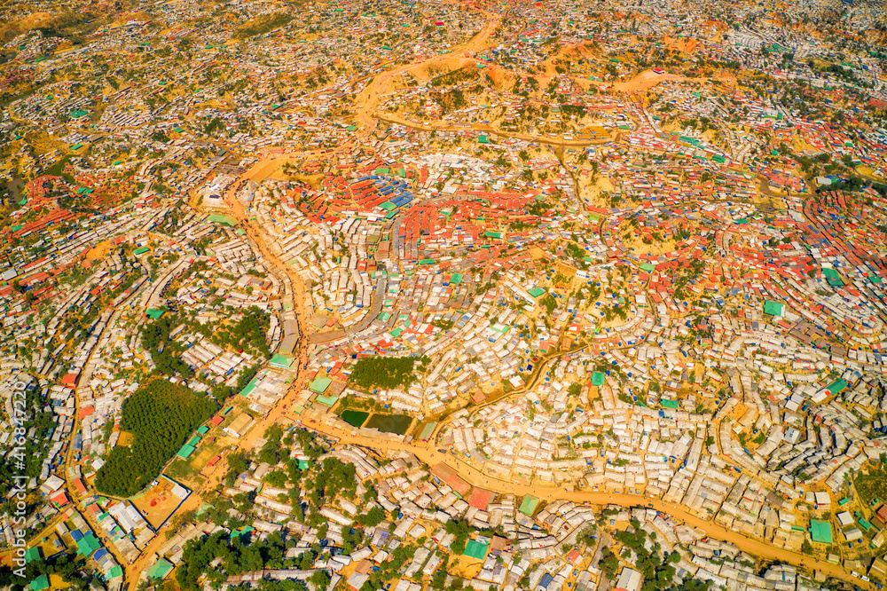 Aerial view of a huge refugee camp with makeshift houses near Myanmar border, Kutupalong Rohingya camp near Ukhia town, Bangladesh. Aerial view of a huge refugee camp with makeshift houses near Myanmar border, Kutupalong Rohingya camp near Ukhia town, Bangladesh.