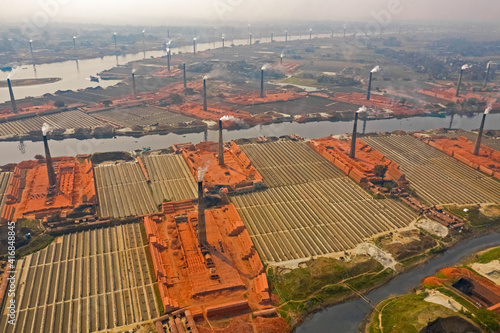 Aerial view of several chimneys from a brick factory along Buriganga river near Keraniganj township, Dhaka province, Bangladesh.