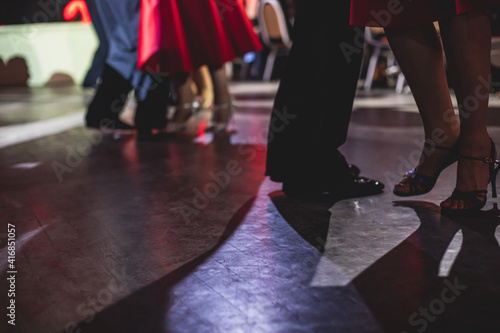Dancing shoes of young couple, Couples dancing traditional latin argentinian dance milonga in the ballroom, tango salsa bachata kizomba lesson, dance festival, wooden floor, close up view of shoes