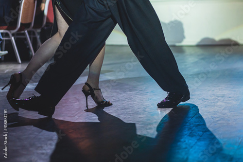 Dancing shoes of young couple, Couples dancing traditional latin argentinian dance milonga in the ballroom, tango salsa bachata kizomba lesson, dance festival, wooden floor, close up view of shoes