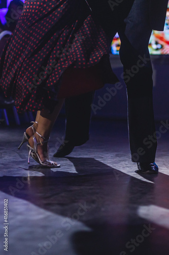 Dancing shoes of young couple, Couples dancing traditional latin argentinian dance milonga in the ballroom, tango salsa bachata kizomba lesson, dance festival, wooden floor, close up view of shoes