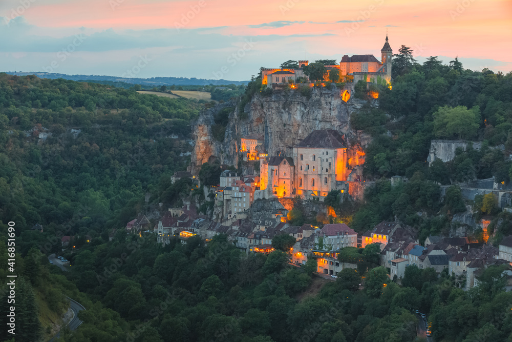 Naklejka premium Colourful sunset or sunrise view of the French medieval hilltop village of Rocamadour, France in the Dordogne Valley.