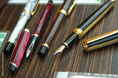 a collection of fountain pens on the table