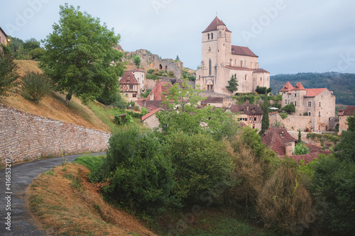 The French medieval hilltop village of Saint-Cirq-Lapopie and its 16th century fortified church in the Lot Valley, France.