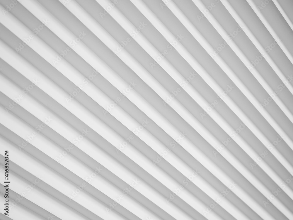 3D panels on the wall in the form of white diagonal stripes with pronounced edges.