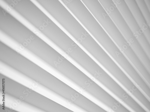 3D panels on the wall in the form of white diagonal stripes with pronounced edges.