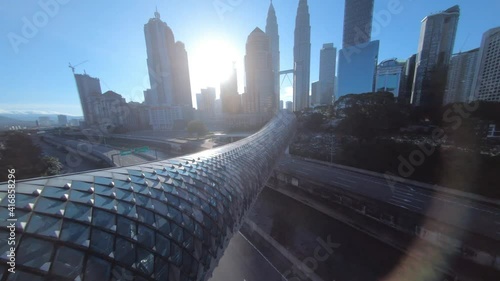 fpv drone view of kuala lumpur pedestrian bridge over speedway highway from city center to village area