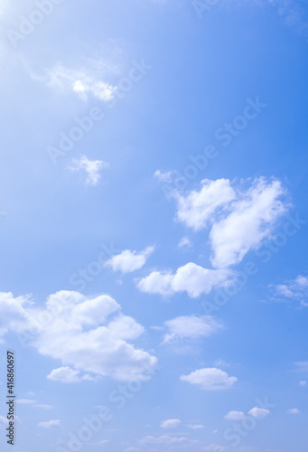 Sunny weather  white clouds and blue sky background  vertical