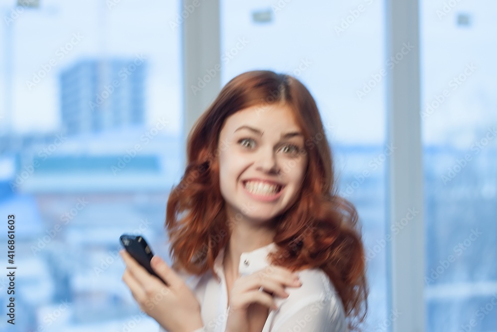 woman in shirt with phone in hand technology professional
