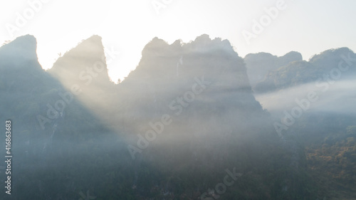 Aerial view of beatiful sunrise over karst mountain peak landscape