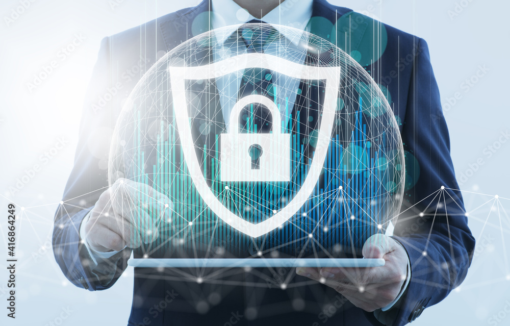 © tadamichi - Computer security. Business person using tablet computer. Data protection system. Network structure and shield icon.