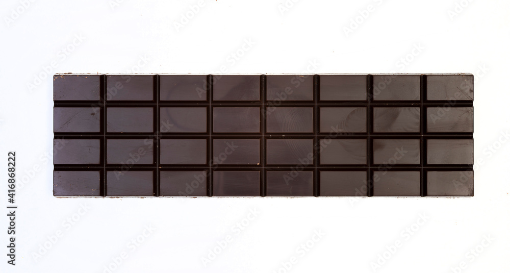 sweet and delicious whole chocolate bar is lying on white background, photo taken from above sweet and delicious whole chocolate bar is lying on white background, photo taken from above
