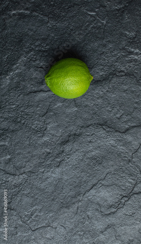 Vertical photo of fresh green lime on black background © azerbaijan-stockers