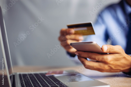 Online payment hands holding credit card and using laptop. Online shopping concept.