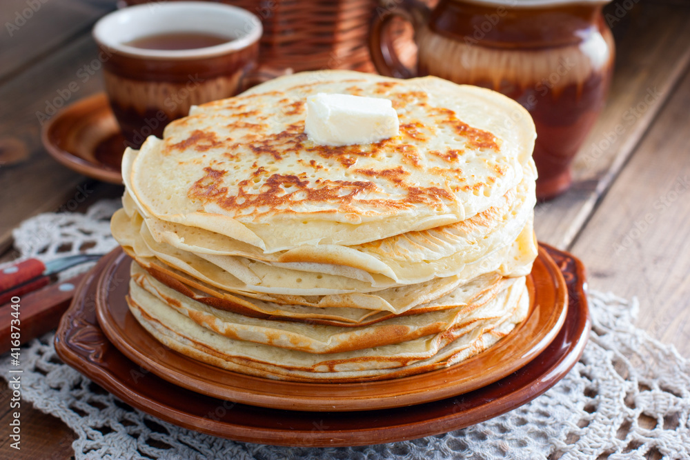 Homemade thick pancakes stacked on a plate, selective focus Homemade thick pancakes stacked on a plate, selective focus