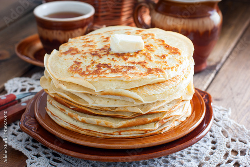 Homemade thick pancakes stacked on a plate, selective focus