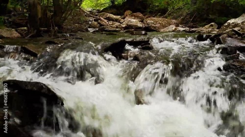 water flowing over rocks in the forest, mountain river in the forest