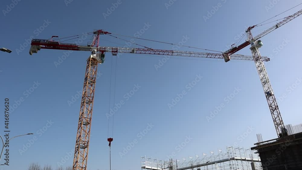 High tower cranes work on building site. Bologna, Italy, construction site High tower cranes work on building site. Bologna, Italy, construction site