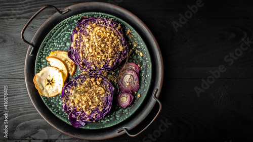 Autumn dish of red cabbage baked with nuts, quince and apples, Vegan roasted red cabbage steaks, Food recipe background. Close up photo