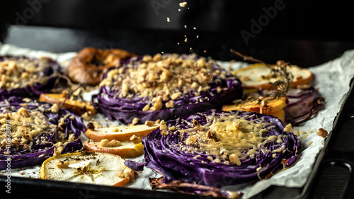 Traditional German dish of red cabbage baked with nuts, quince and apples, chef cooking autumn dish of red cabbage baked photo
