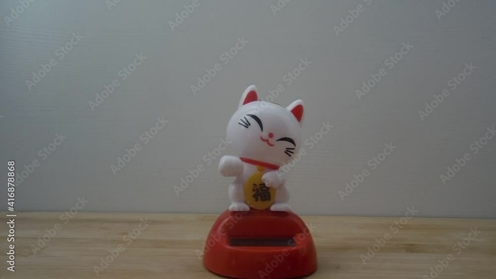Maneki Neko plastic Japanese lucky cat figures on white backgrund. Japanese characters means good luck or fortune. Maneki Neko plastic Japanese lucky cat figures on white backgrund. Japanese characters means good luck or fortune.