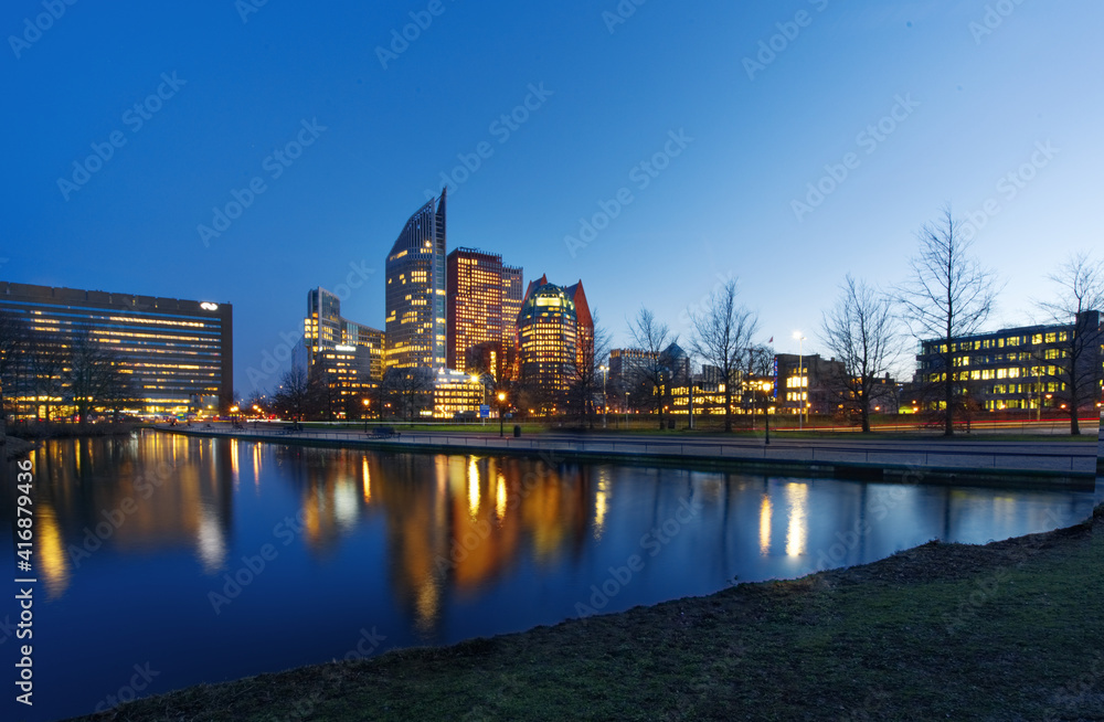Night city skyline of Hague, Netherlands, with reflection on the canal of Amsterdam