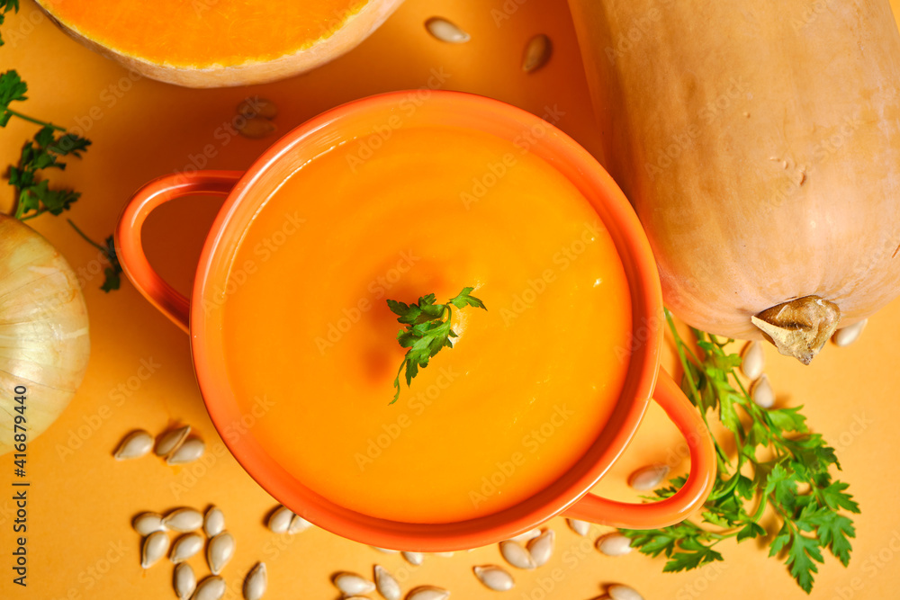 Pumpkin puree photographed from above all orange like pumpkin with pumpkin pipes on the orange table and pumpkins in the background decoration, one whole and the other cut in half Pumpkin puree photographed from above all orange like pumpkin with pumpkin pipes on the orange table and pumpkins in the background decoration, one whole and the other cut in half
