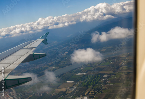 Landing in city of Vancouver. mountains  lakes and rivers outside a plane window. Travel time  sky  clouds and plane wing. Aerial view