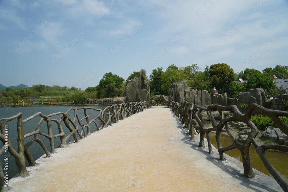 Concrete walkway above a park lake