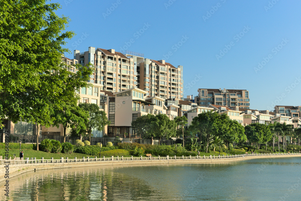 Buildings on the waterfront in sunny weather with blue background