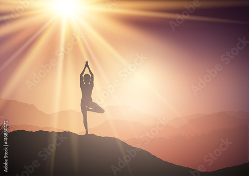 Female in yoga pose in sunset landscape
