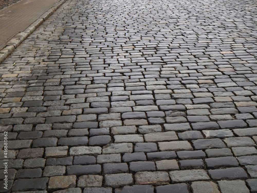 dirty gray cobbled road perspective
