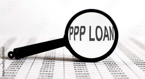 Magnifier with text PPP LOAN on the chart background photo