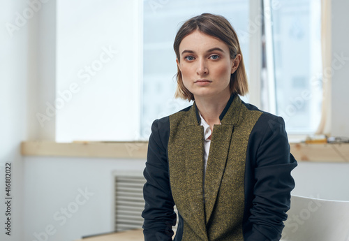 Portrait of a business woman in a suit In a bright room near the window