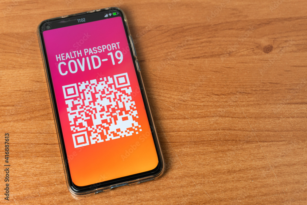 Phone with Digital Health Passport Covid-19 App on table Phone with Digital Health Passport Covid-19 App on table