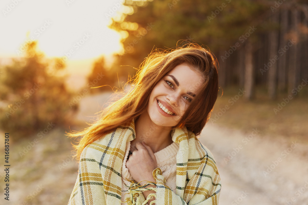 Happy woman with bread on her shoulders laughs front view and sunset in the background Happy woman with bread on her shoulders laughs front view and sunset in the background