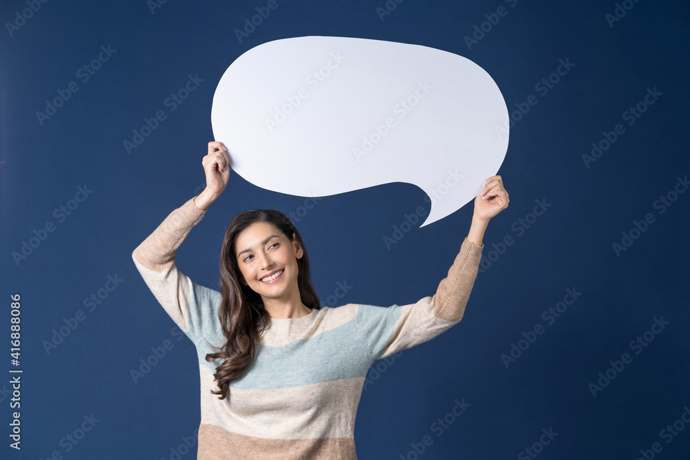 Happy young smiling Asian woman holding copy space empty message bubbles on blue color background, thinking and specking via balloon blank paper, Private opinion for advertisement Concept