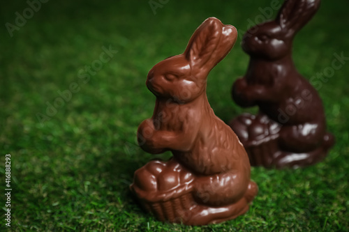 Chocolate bunnies on green grass  space for text. Easter celebration