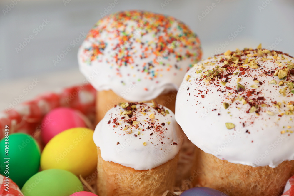 Traditional Easter cakes and dyed eggs on blurred background, closeup Traditional Easter cakes and dyed eggs on blurred background, closeup